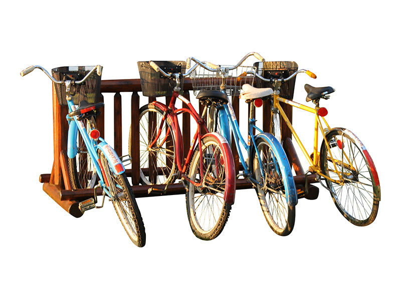 Log freestanding bike rack shown holding 4 different beach cruisers with varying colors.  The image is over a white background. 