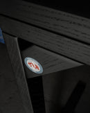 Rear view of the blackout freestanding surf rack showing a "Hand-Made USA" logo with the epic surf racks diamond logo, and the california bear on the flat-black wooden rack.