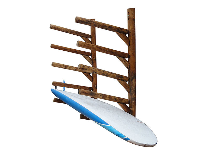Canyon brown finish on 5 board SUP wall rack. The rack is holding a blue stand up paddle board SUP on the lowest level. The wood is a dark brown color. The rack is mounted to a white wall.  The rack is made of wood logs. 
