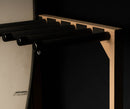 Top half of red oak freestanding surfboard rack on black background with dramatic lighting.
