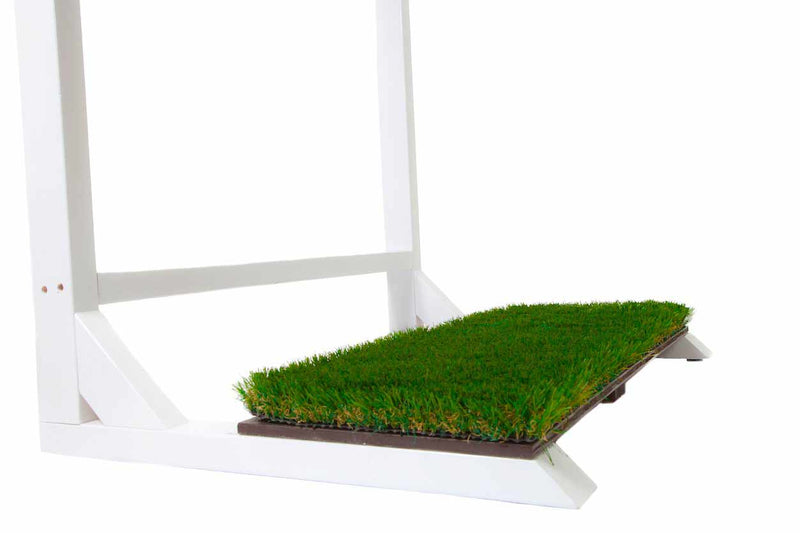 Close up image of the bottom of the White MarshMellow Grass FreestandingSurf Rack.  The grass base is green, and is sitting on a brown board that gives the grass stability. 