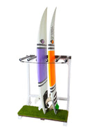 MarshMellow Grass Surf Rack shown holding two surfboards. One surfboard has purple and black stripes. The other surfboard has orange and black stripes.