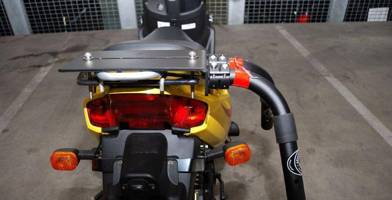 Motorcycle & Moped Surfboard Rack | Single-Mount shown mounted to the back of a yellow moped. 