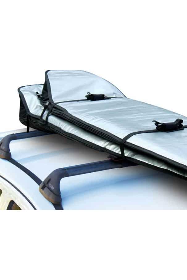 Rax pads shown holding two surfboards and being tied down by buckles to the roof of a car.