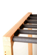 Foamy Surf Rack top portion of the rack showing the sanded wood grain. There are several foam covered dowels coming off the rack perpendicular.