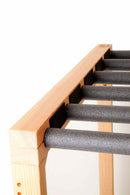Close up detail shot of the Grassy Surf Rack top of the wooden freestanding rack. The image is on a white background.