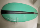 Acrylic flush mount surfboard rack shown holding a green surfboard with a black stripe. The board is mounted pretty close to the wall, and the board has a sticker that says epic surf racks in the lower left corner of the board.