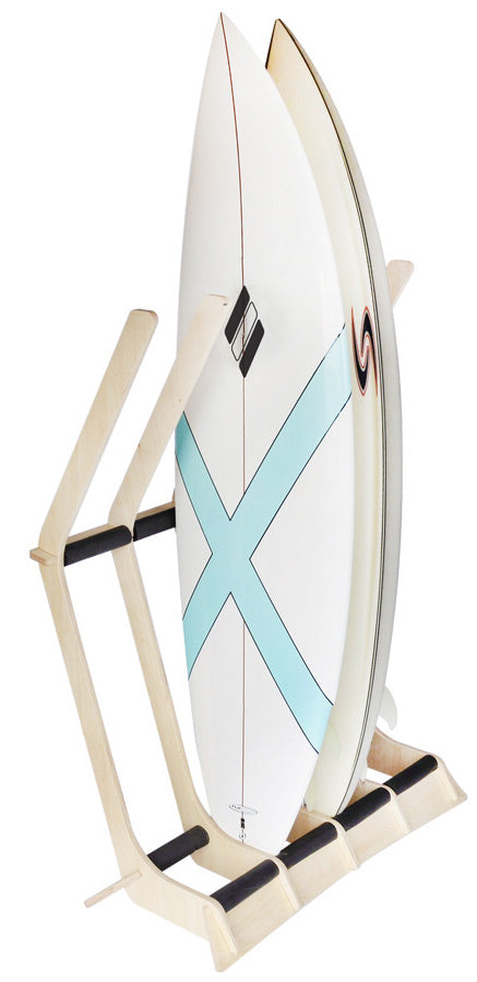 4 surfboard floor rack freestanding shown holding two surfboards.  The wooden rack is very light in color and has black padding to protect the surfboards.  The image has a white background. 