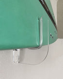 Close up image of the acrylic flush mount surfboard rack. The image shows how close the surfboard is mounted to the wall using the rack. The clear rack also has a clear strip protecting the surfboard from damage.