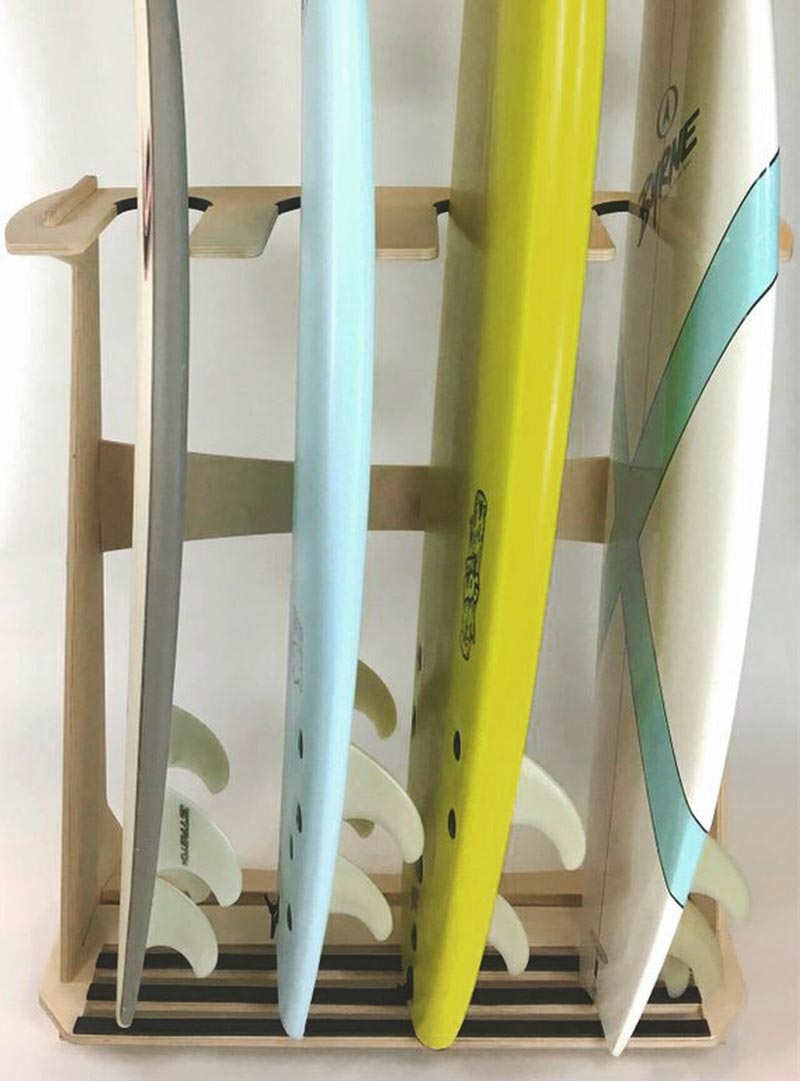 Front angle of premium 4-board freestanding surfboard rack showing it filled with a variety of  surfboards, and other watercraft..