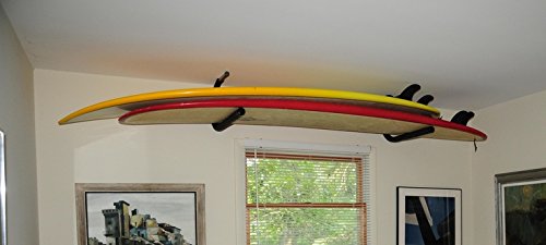 The SUP & Surfboard ceiling rack shown mounted inside the home of a customer.  The rack is holding two surfboards, and is mounted just above a window. 
