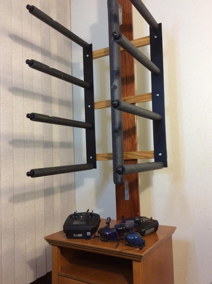Customer photo showing how he mounted his Berghwing rack.  there are several radio controllers for berghwings below the rack on a wooden shelf. 