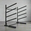 4-level sup freestanding rack for surfboards.  Made of black metal in a room with a grey floor and wall behind it. 