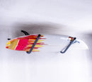 Angle Metal 45 degree wall rack shown holding a surfboard that has red and yellow paint on it. 