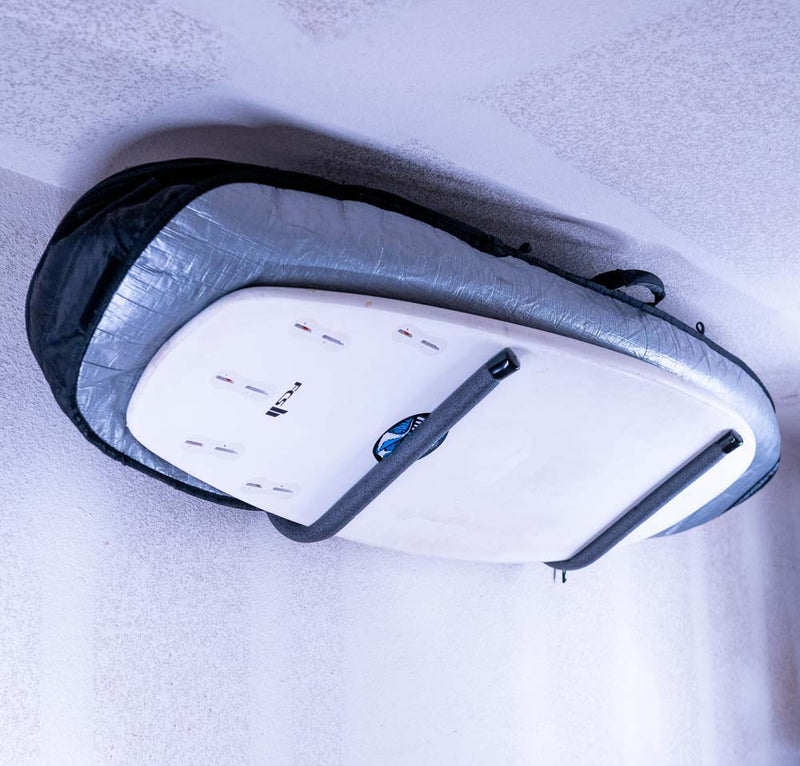 Angled Metal 45 degree wall rack shown holding several surfboards stacked on each other. 