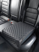 Booostedsafe shown installed in the backseat of a luxury vehicle with the included security cover installed and in the locked position. 