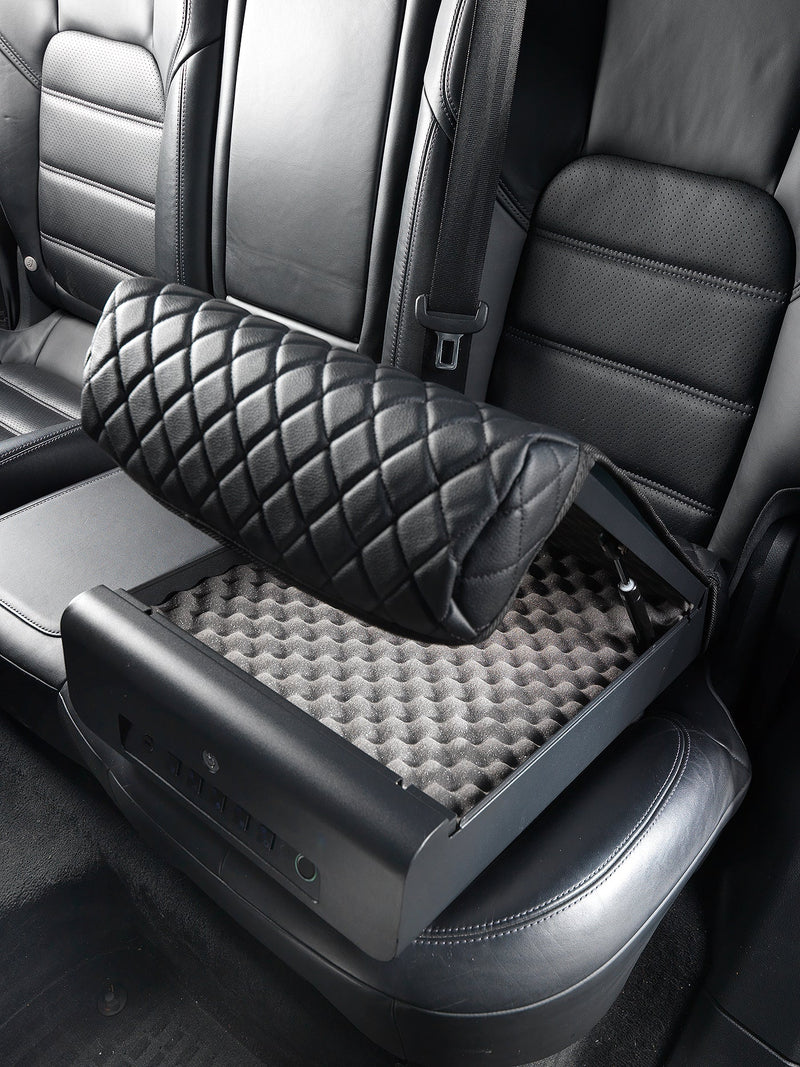 Boostedsafe shown with the security cover in the opened position while it is locked to the backseat of a vehicle. 