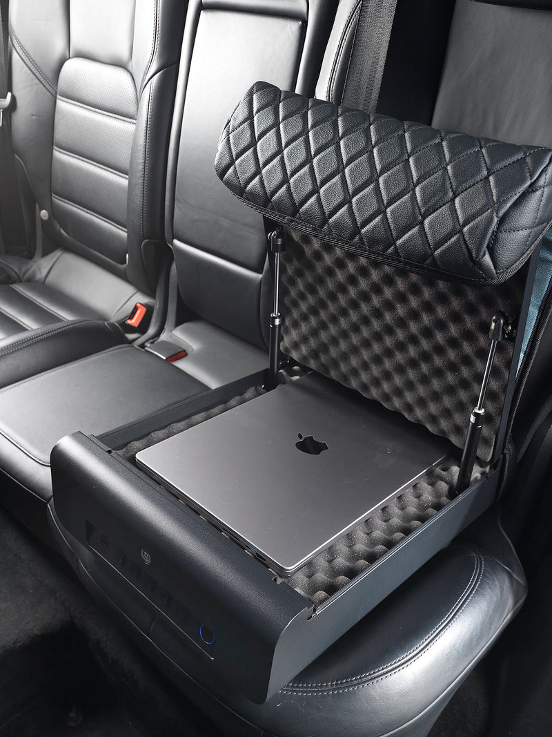Boostedsafe shown locked to the vehicle with a laptop on a black car seat