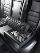 Boostedsafe shown locked to a vehicle backseat holding multiple guns with the safety cover is shown that hides the safe. 