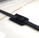 close up of the internal cinch straps that keep the surfboard locked inside the travel bag.  neoprene padding below the buckle protects the surfboards glass. 