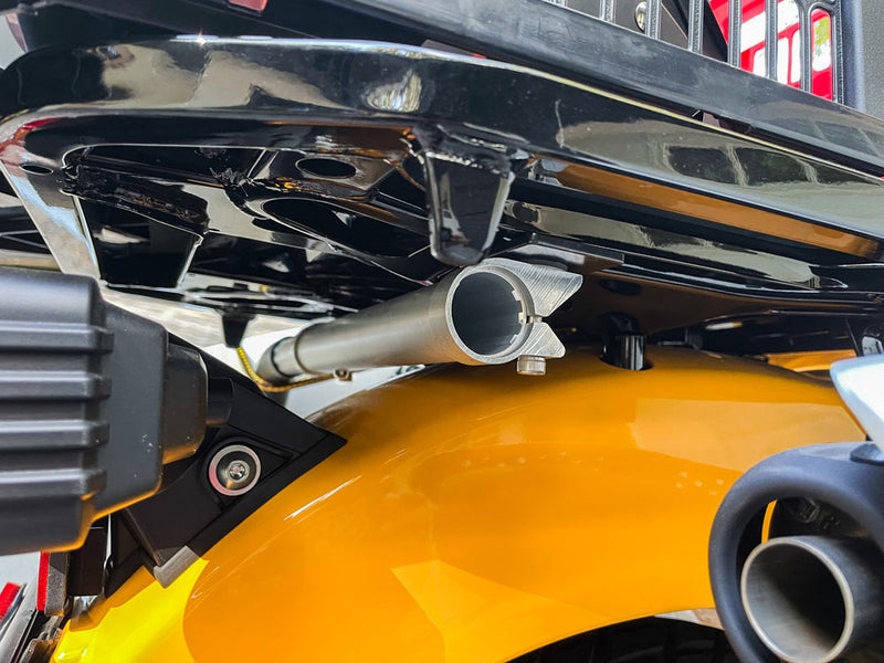 Side view of the moped surfboard rack attached to the rear mount-point of a Honda moped. The moped's luggage rack is gloss black. The moped is yellow.
