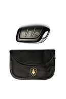 Overhead view of the Far King RFID key fob pouch that is included with the Keysafe deluxe lock box. There is also a key fob next to the pouch to show sizing of the pouch. 