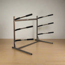 3-Level SUP & Surfboard rack in a room with a wooden floor.  The rack is dark grey and made of metal. 