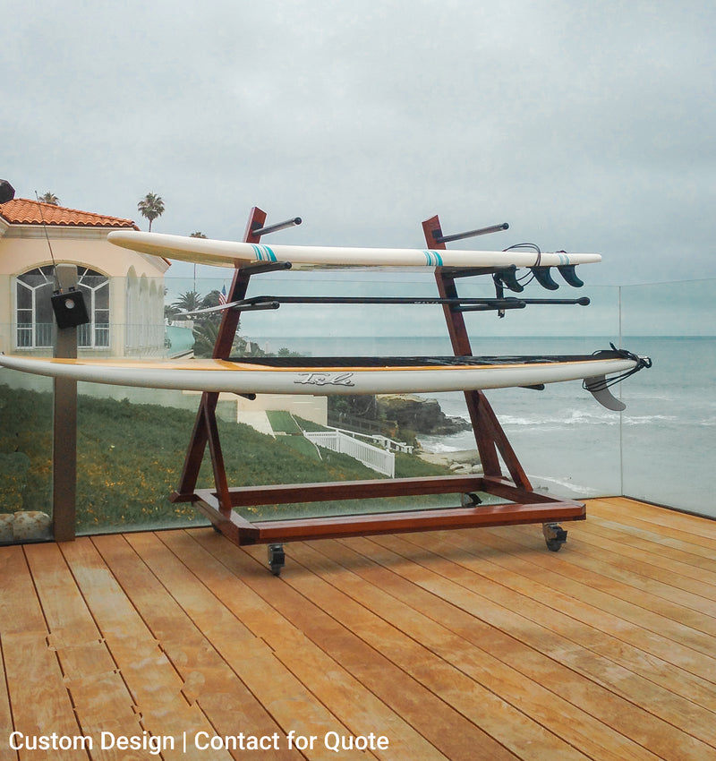 Dark Brown Mahogany Tower Rack shown in a custom build. The rack is shown on the deck of a beachside home. The rack has locking wheels at the bottom of it so it can move freely. The house has glass railings along the deck.