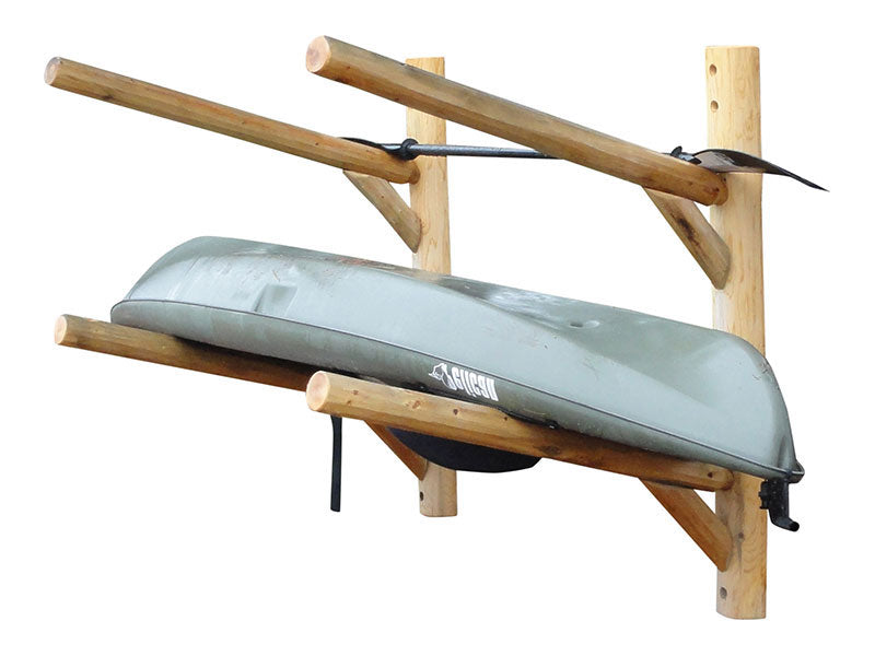 Picture of the Two-Level Kayak, Canoe, and SUP Wall Rack for 1-3 watercraft.  The rack is made of wooden logs, and shows it holding a grey kayak on the lower level, and a paddle shown held on the top level.  The image is on a white background. 