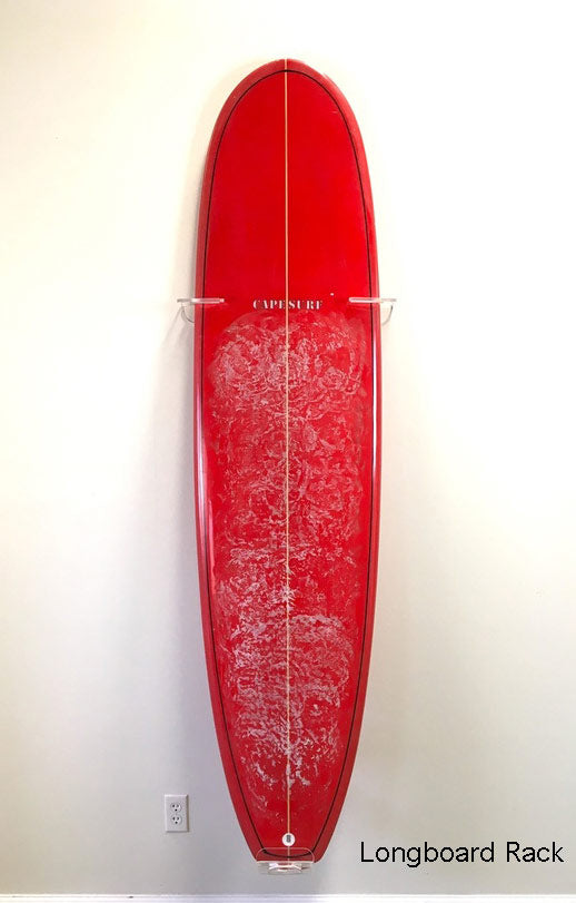 Longboard Acrylic Front facing wall rack with red surfboard.  The display rack is pretty much clear.  The rack is mounted to a white wall.  The text "Longboard Rack" is in the lower right side of the image. 