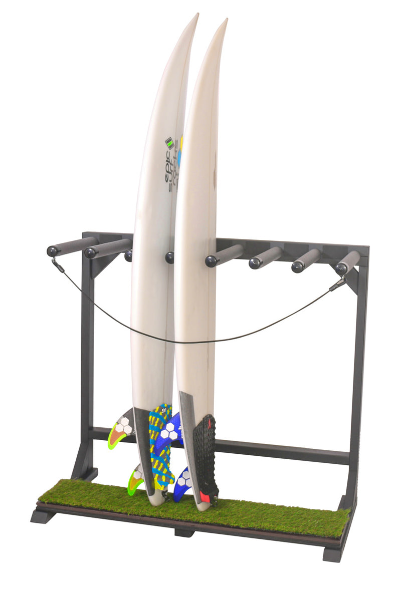 BlackOut Grassy Surf vertical freestanding Rack shown holding two white surfboards.  The rack is flat black in color, and has a faux grass part at the bottom where the surfboards sit. 