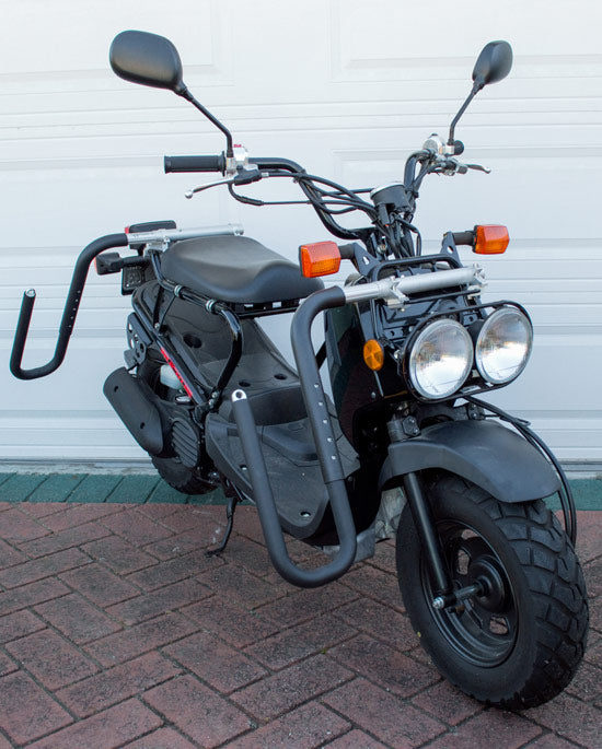 Dual-Mount Moped surf rack showing that it can also be mounted with it's dual-c clamp mounting system on a moped rack as well. The rack is mounted on a black Honda Ruckus