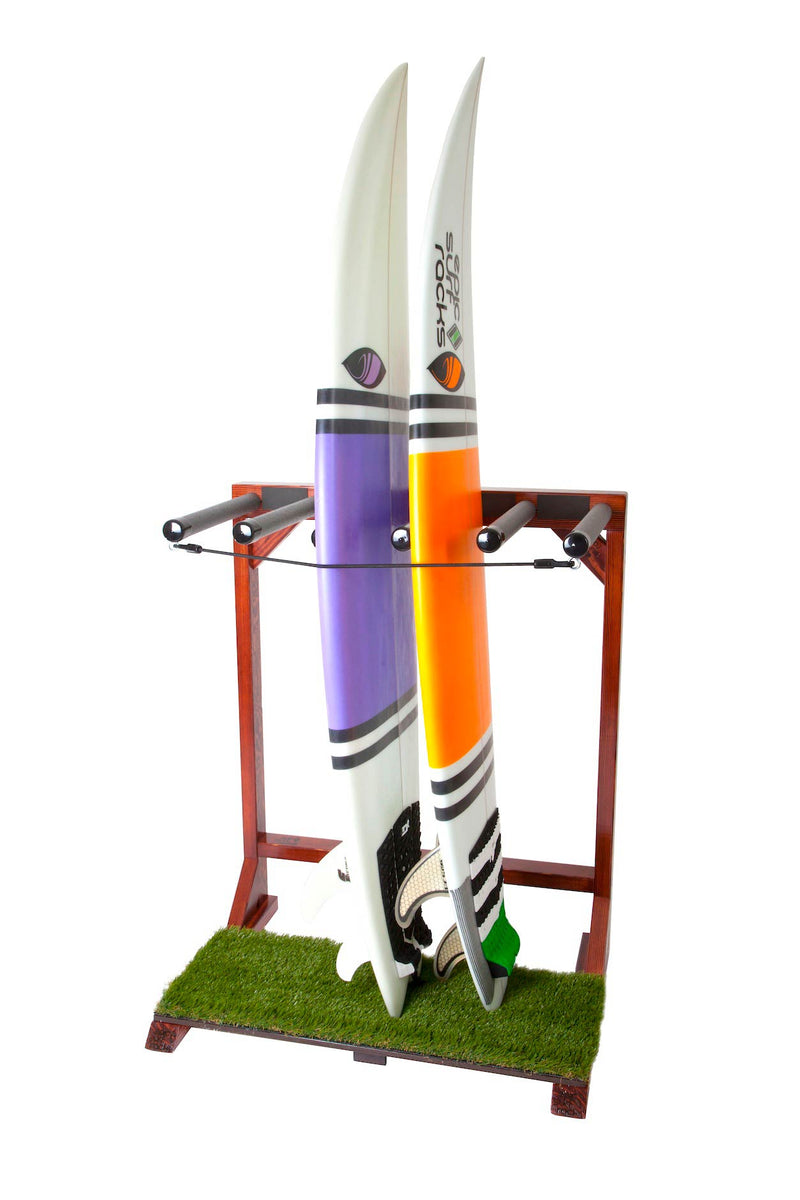 Finished Grassy Surf Rack shown on a white background.  There is a grass base at the bottom of the surf rack where the surfboards sit.  There is a purple surfboard  and an orange striped surfboard sitting in the rack. Both boards are secured using the black bungie locking mechanism. 