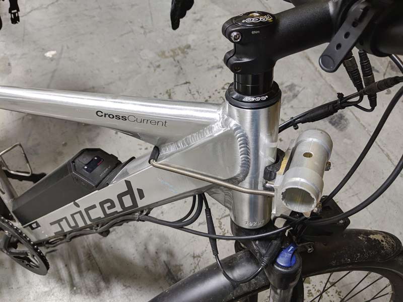 Included mounting hardware: U-bar shown mounted to a silver mountain bike.  This mount secures the front part of the surfboard or Stand Up Paddle Board rack. 