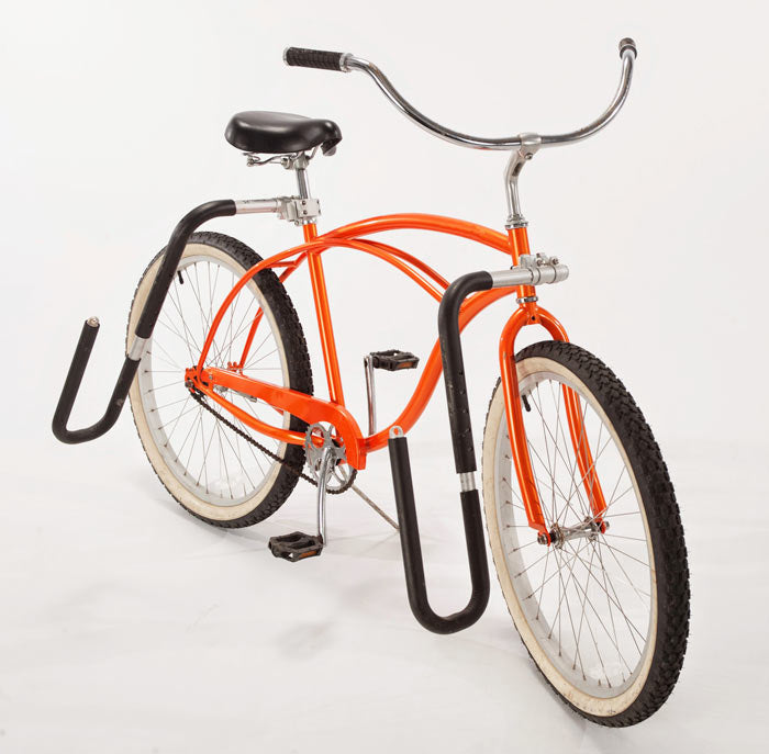 SUP Bike Rack shown with the included "surfboard hooks".  The surfboard rack is mounted to an orange beach cruiser. 