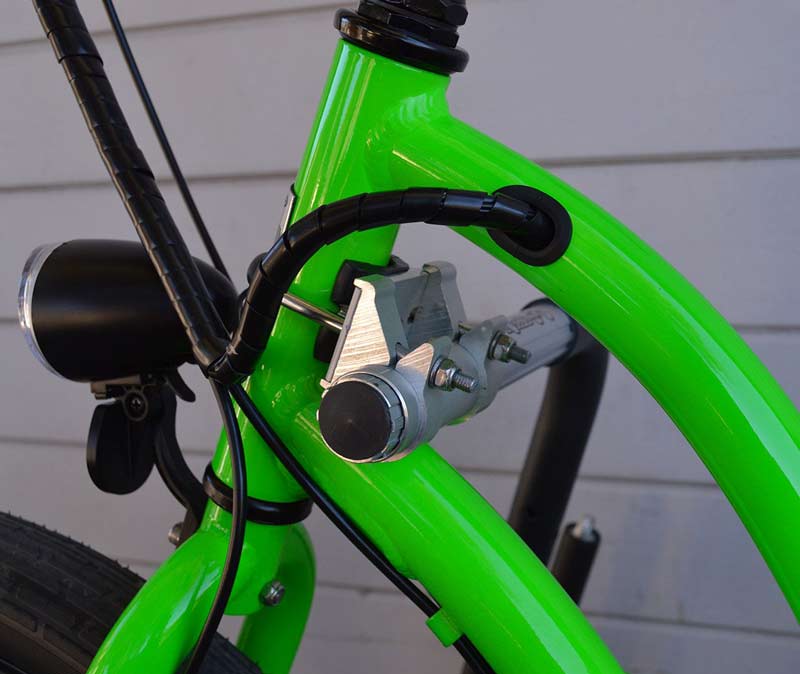 Close up detail shot of the Front Mount installed on green bicycle. The mount is used for the dual-mount surfboard and SUP bicycle rack.