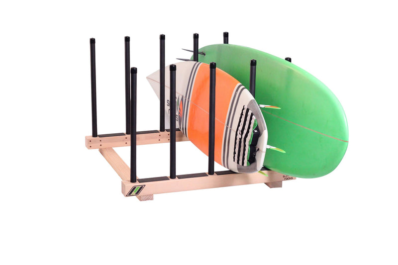 The Pig Dog - Floor Rack for Surfboards & SUP wooden surf rack shown holding two surfboards in the horizontal position.  The rack is sitting on a white floor. 