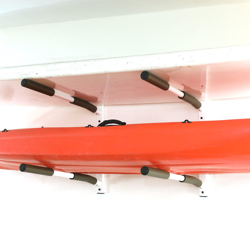 The 2-level SUP & Kayak White wall rack shown on a white wall holding one white stand up paddle board, and one small red kayak.  