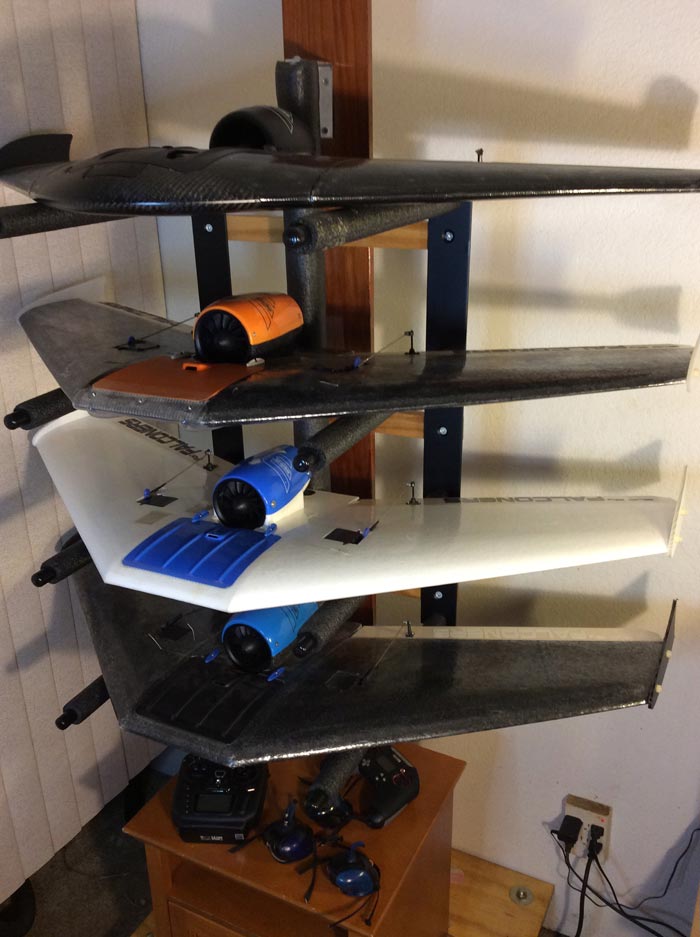 Berghwing Storage rack holding 4 flyers stored flat with several control modules below. 