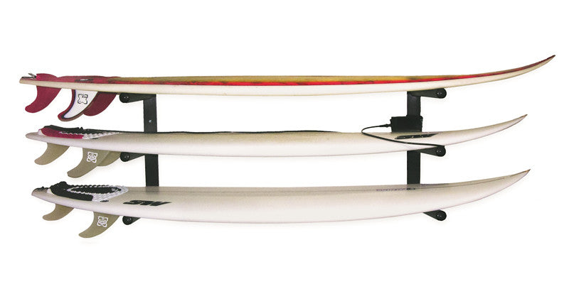 Black metal surfboard rack holding 3 high performance surfboards with their fins installed.  The top board has red and yellow on it.  